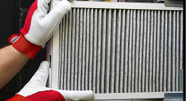 Hands holding a clean HVAC filter from Gering Valley Plumbing & Heating