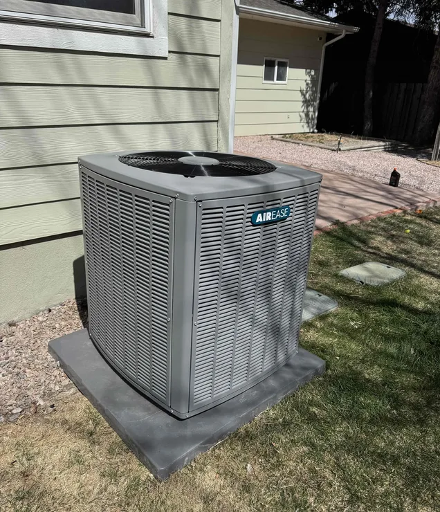 Gering Valley technician performing annual AC maintenance tune-up on a central air conditioning system