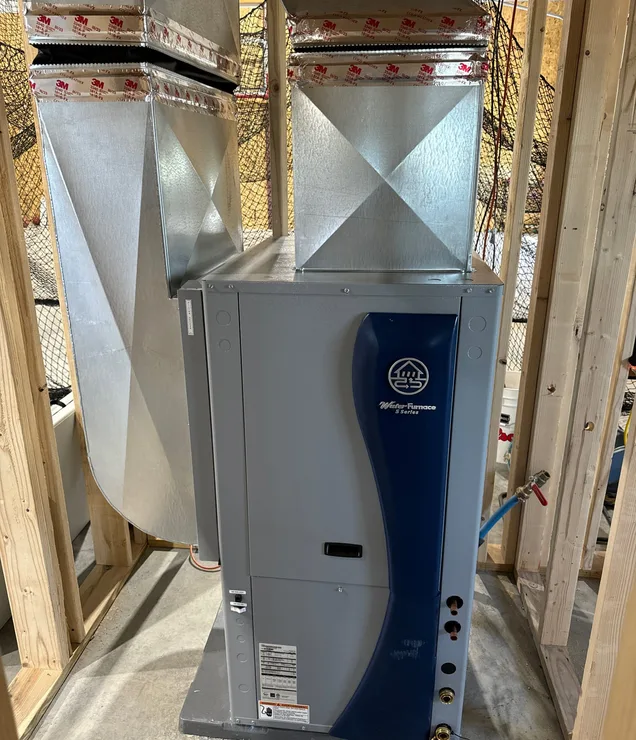 Gering Valley technician inspecting a geothermal heat pump system
