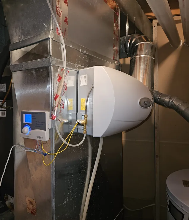 Gering Valley technician installing an indoor air quality system in a Nebraska home