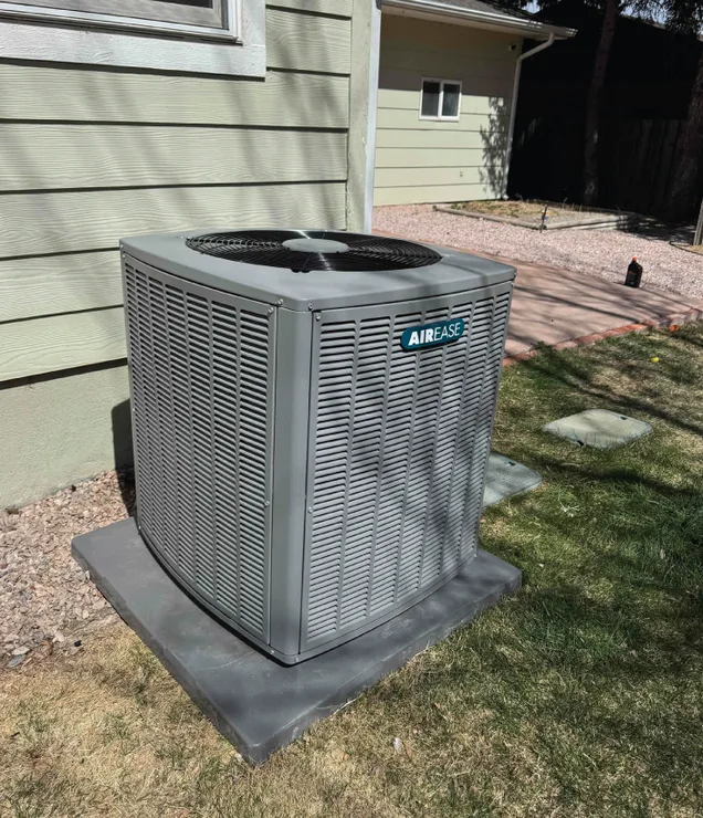 Gering Valley technician beside a central air conditioning unit