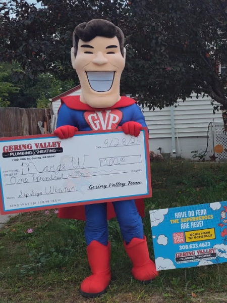 September yard-sign winner Marge W. with their Gering Valley Plumbing & Heating sign