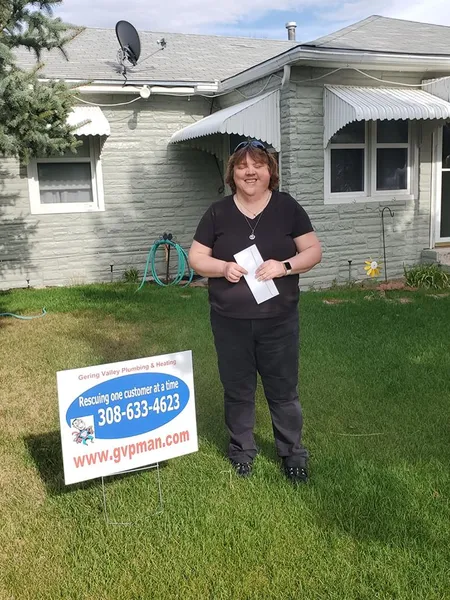 April yard-sign winner Tellina with their Gering Valley Plumbing & Heating sign