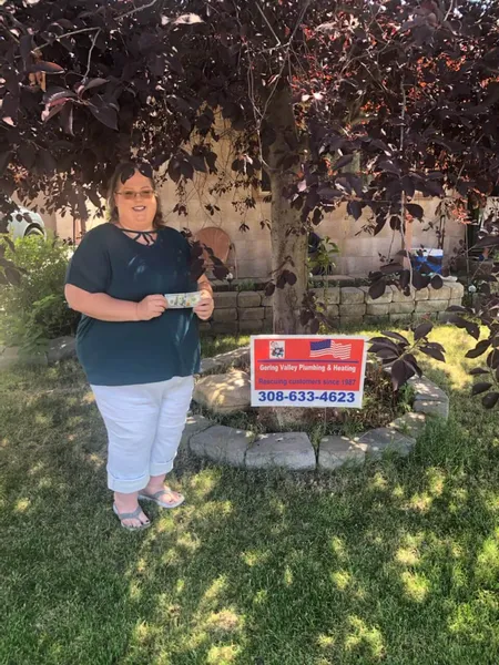 July yard-sign winner Devonna with their Gering Valley Plumbing & Heating sign
