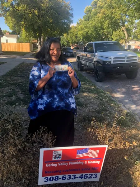 September yard-sign winner Lydia with their Gering Valley Plumbing & Heating sign