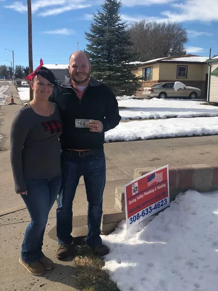 October yard-sign winner Brian and Brittany with their Gering Valley Plumbing & Heating sign