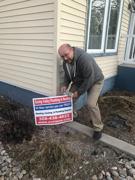 November yard-sign winner John with their Gering Valley Plumbing & Heating sign