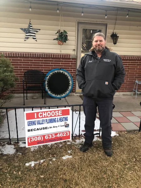 January yard-sign winner Neal with their Gering Valley Plumbing & Heating sign