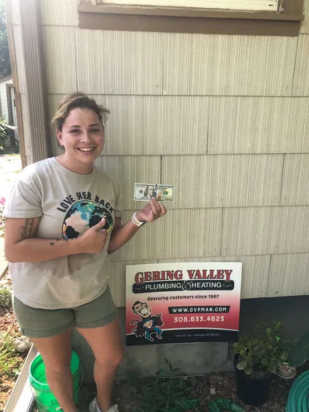 July yard-sign winner Tera with their Gering Valley Plumbing & Heating sign
