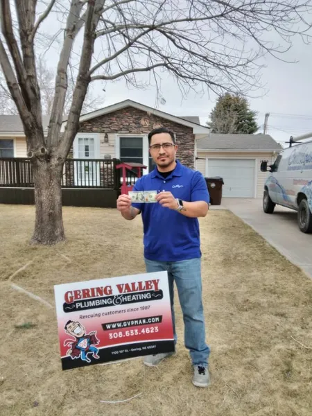 March yard-sign winner Rene with their Gering Valley Plumbing & Heating sign