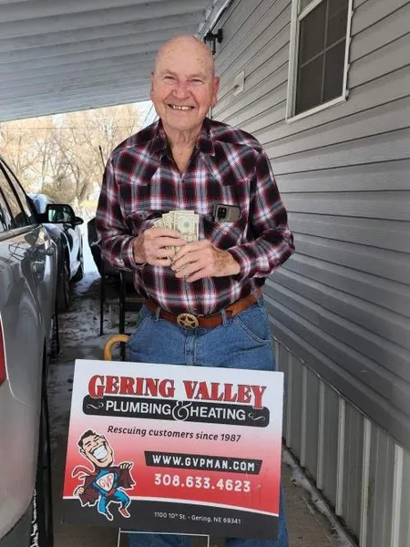 December yard-sign winner Clyde with their Gering Valley Plumbing & Heating sign