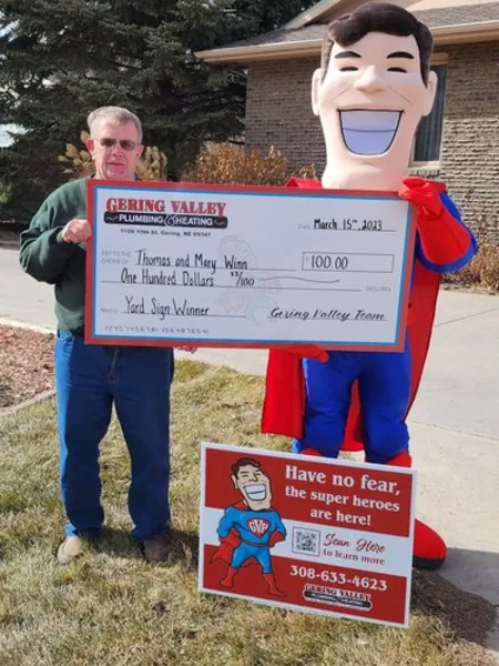 March yard-sign winner Thomas with their Gering Valley Plumbing & Heating sign