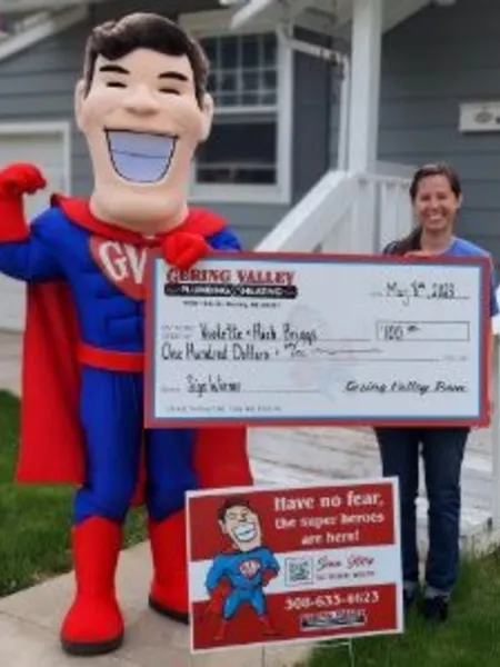 May yard-sign winner Violette with their Gering Valley Plumbing & Heating sign