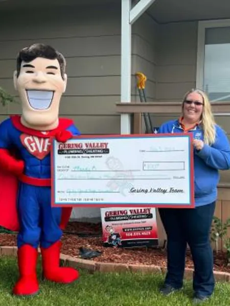 July yard-sign winner Mandy with their Gering Valley Plumbing & Heating sign