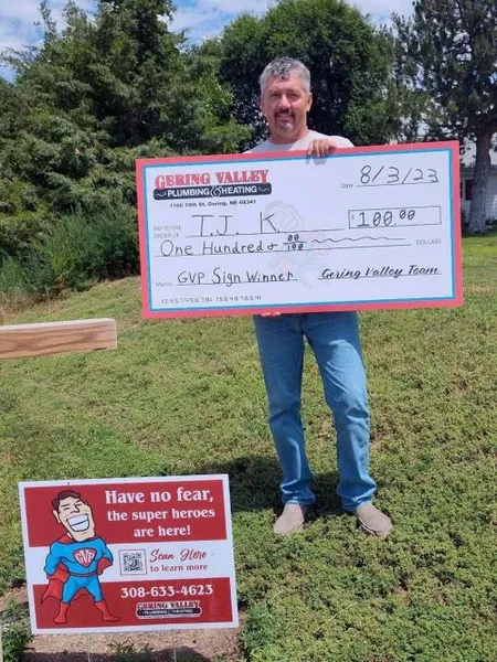 August yard-sign winner T.J. with their Gering Valley Plumbing & Heating sign
