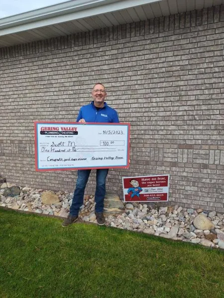October yard-sign winner Scott M. with their Gering Valley Plumbing & Heating sign