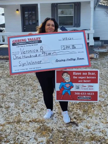 January yard-sign winner Veronica R. with their Gering Valley Plumbing & Heating sign