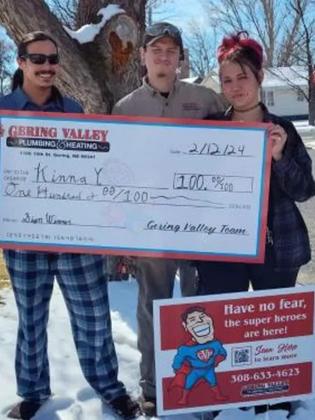 February yard-sign winner Kinna Y. with their Gering Valley Plumbing & Heating sign