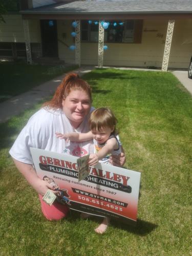 Gering Valley Plumbing & Heating Monthly Sign Winner for June, Clara B after receiving her $100 for leaving her sign in after she called Gering Valley Plumbing & Heating for help.