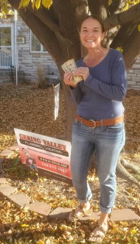 Gering Valley Plumbing & Heating Monthly Sign Winner for June, Clara B after receiving her $100 for leaving her sign in after she called Gering Valley Plumbing & Heating for help.